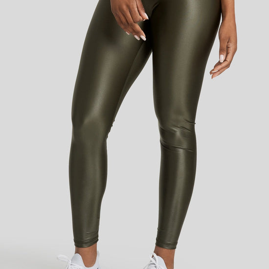 A woman's legs are shown wearing hi gloss olive colored leggings
