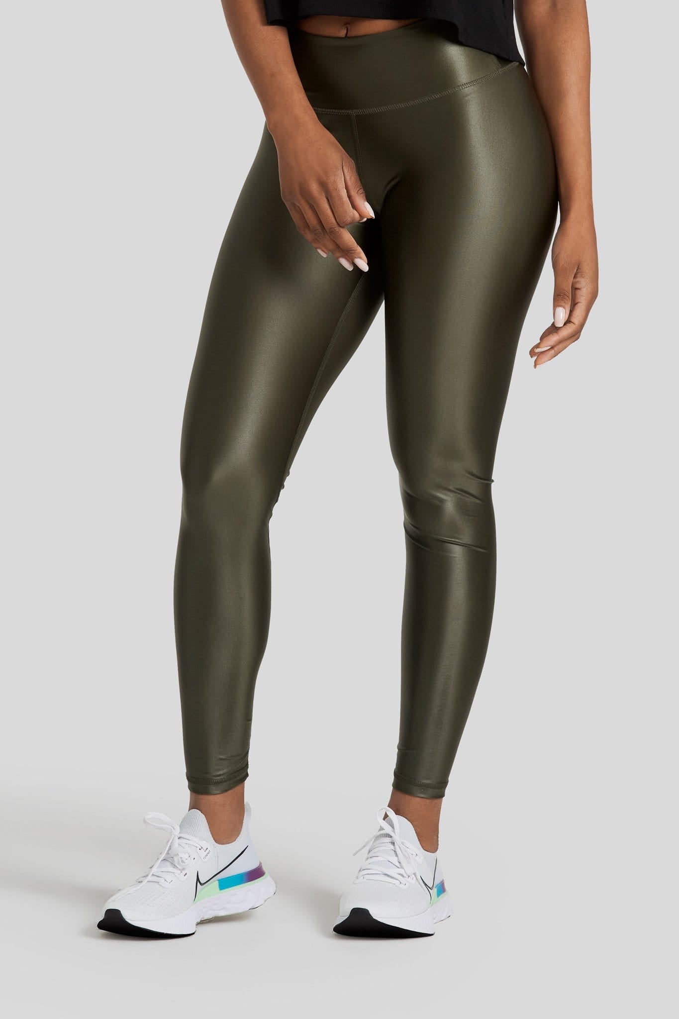 A woman's legs are shown wearing hi gloss olive colored leggings