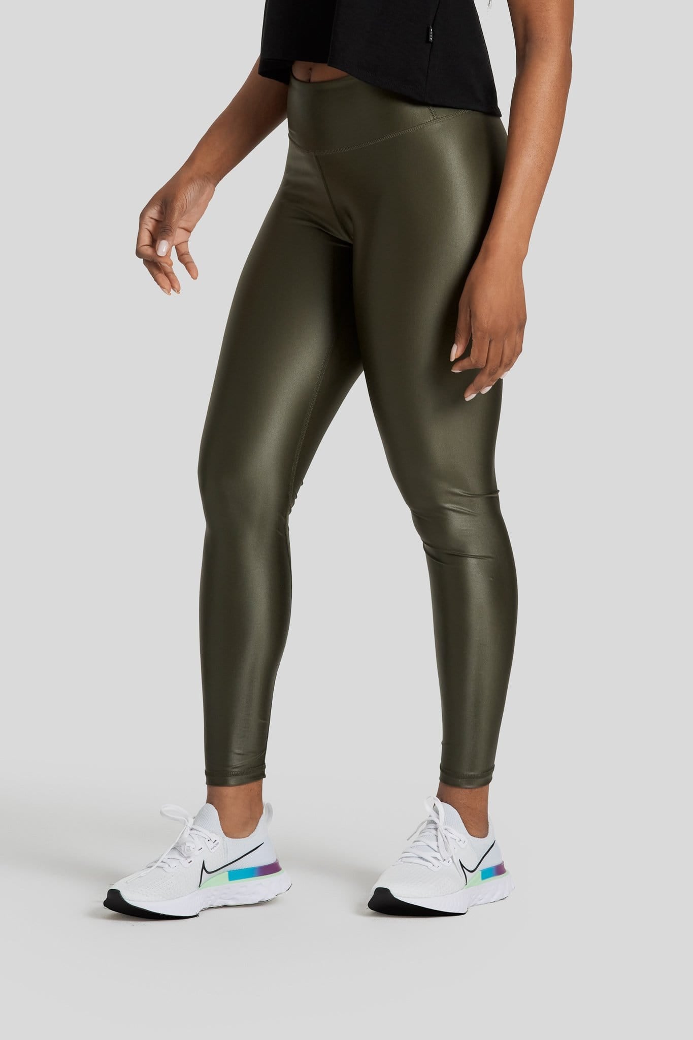 A woman's legs are shown wearing liquid olive colored leggings