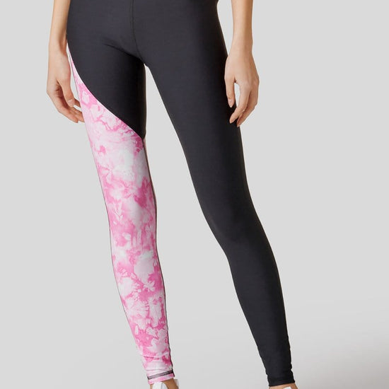 Front of leggings shown with one black leg and one leg in tie-dye pink