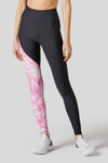 Front of leggings shown with one black leg and one leg in tie-dye pink