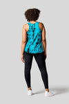 Back of a women wearing a blue tie dye tank top, black leggings and Nike Air Force shoes