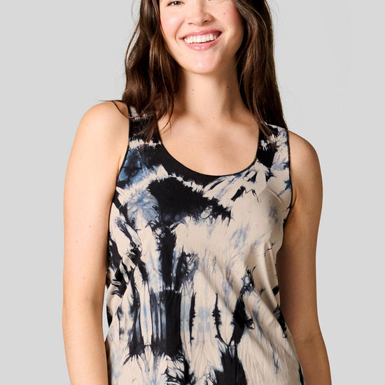 A brunette woman wears a tie-dye tank that's made in Vancouver Canada.