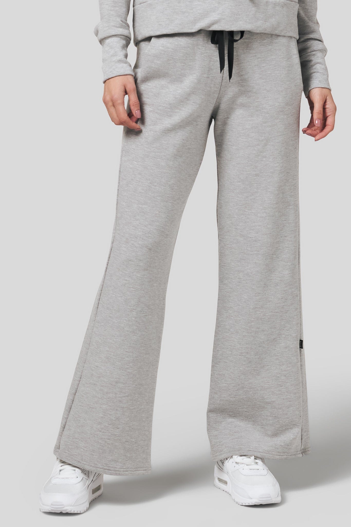 Women wearing a wide leg sweatpants in light heather grey