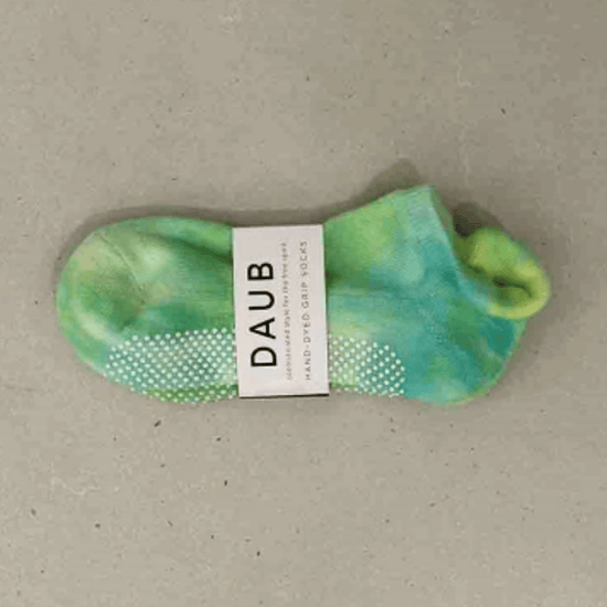 Hand dyed grip socks in Lime placed horizontally