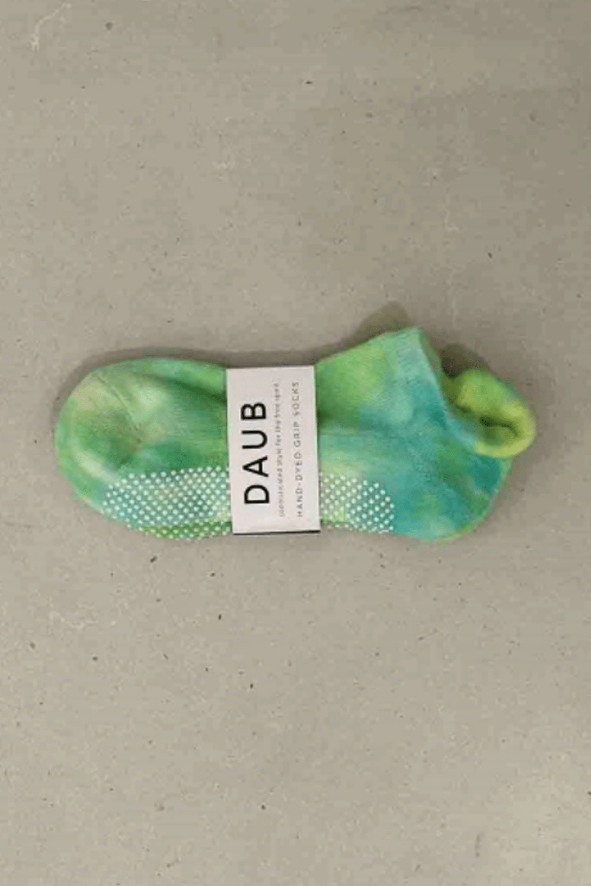 Hand dyed grip socks in Lime placed horizontally
