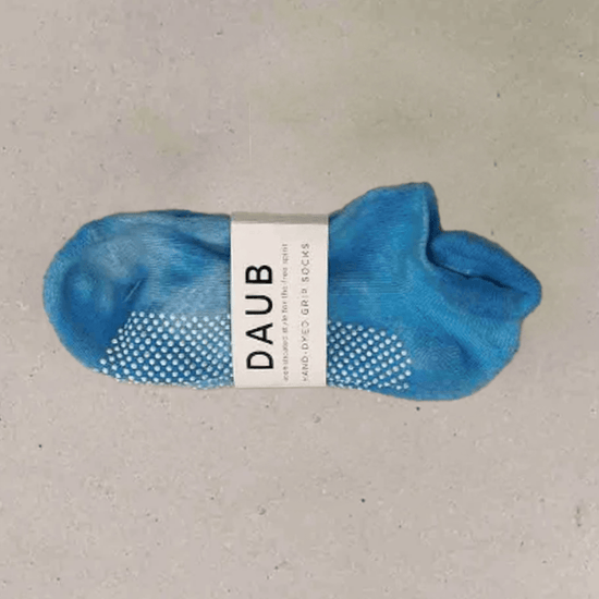 Hand dyed grip socks in Ocean placed horizontally