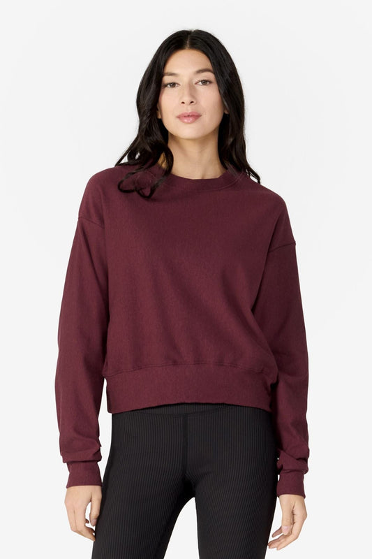 girl facing front wearing a dark red long sleeves sweater