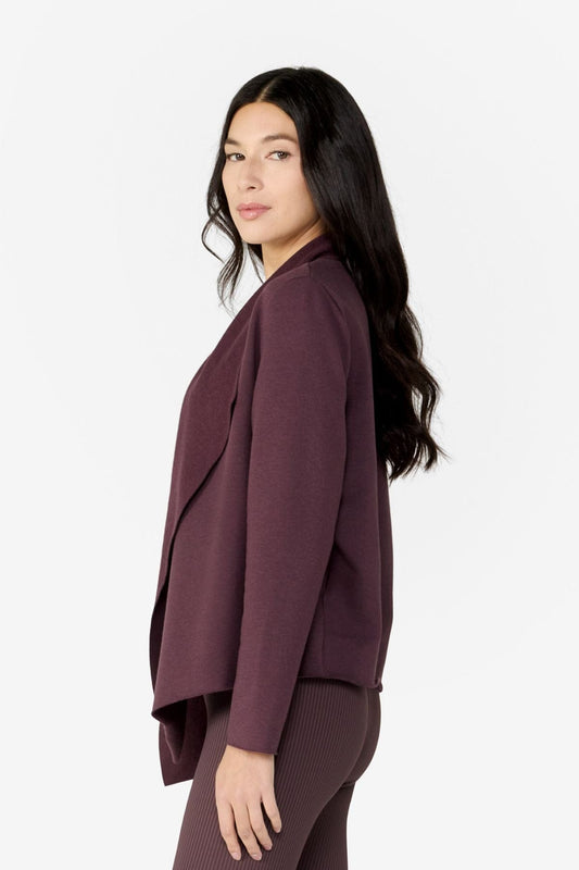 Girl on side wearing a deep brown purple hiplength long sleeves jacket