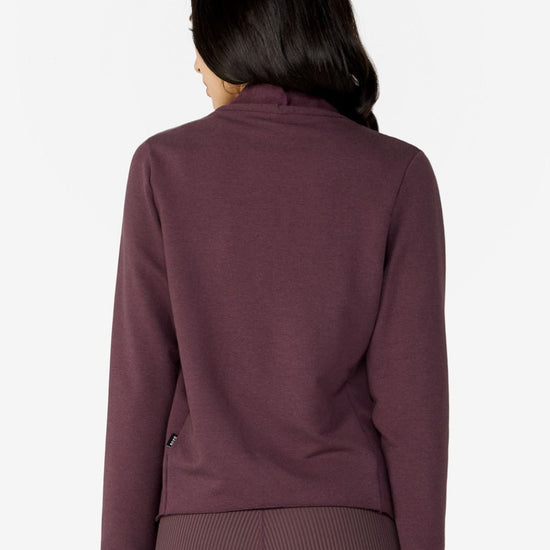Girl on backside wearing a deep brown purple hiplength long sleeves jacket