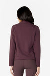 Girl on backside wearing a deep brown purple hiplength long sleeves jacket