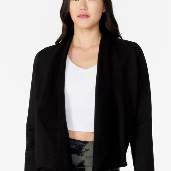 Woman wearing a hiplength black jacket
